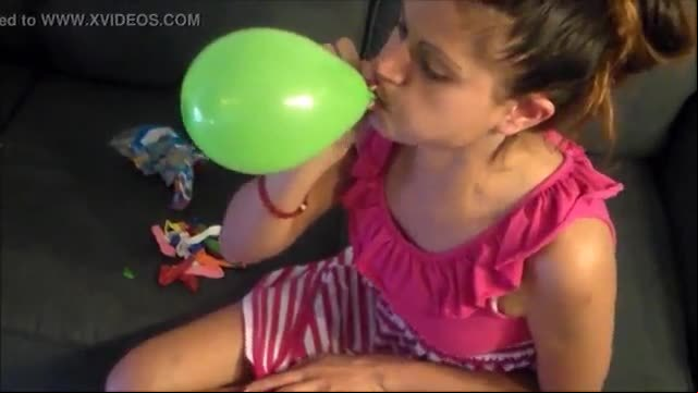 Yesenia blows balloons and pops them with her nails
